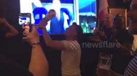 British fan celebrates with replica World Cup trophy after Harry Kane scores late goal