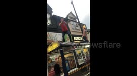Man leaps from bus shelter into crowd celebrating England win
