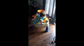 Twins play peek a boo while sitting in water table
