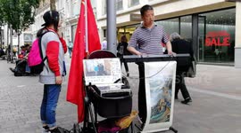 A Chinese blind man musician busking outside Harrods