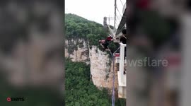 Thrillseeker takes leap of faith as he jumps off the world's tallest footbridge.