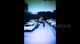 Bed thrown from building knocks courier off his scooter