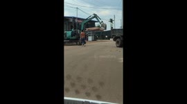 The seven-year-old boy drove the excavator on the road