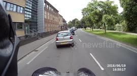 Car drives along pavement to undertake queue of traffic.