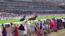Racegoers enjoy a close view of horses and jockeys before the Hampton Court Stakes on Ladies Day of the Royal Ascot 2018