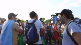 Argentine and Brazilian fans embrace at the Fan Fest in Moscow