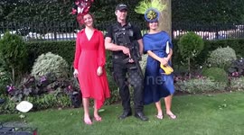Ladies are posing for a photo with a policeman on Ladies Day - Royal Ascot 2018