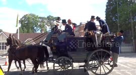 Horse-drawn carriage with passengers is moving along Ascot High Street at the end of Ladies Day - Royal Ascot 2018