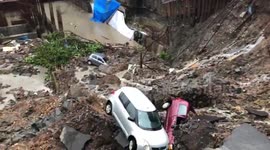 Wall collapses burying several cars following heavy rains in south Mumbai