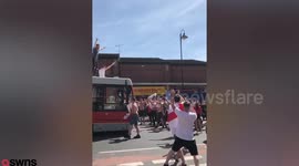 England fans celebrating by surfing on a bus