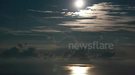moon sets in Adriatic while thunderstorm developes