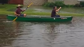 Canoeing down flooded streets in Arizona