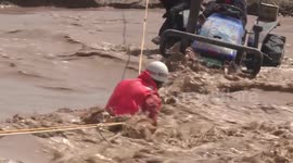 Hero firemen swim through flash floods to save trapped couple