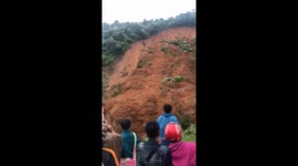Terrifying moment two men escape death as landslide sweeps away road