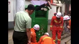 Firefighters free man stuck in recycling bin
