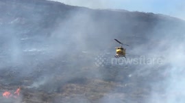 Newsflare Edit - Helicopter drops water on fire outside Los Angeles