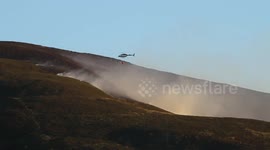 Helicopter drops water to fight Saddleworth Moor in Greater Manchester