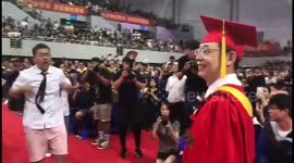 Students perform dance in front of university president at graduation