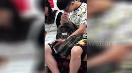 Shanghai commuter uses girlfriend's finger to pick his nose