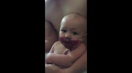 This messy baby loves a good berry smoothie