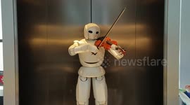 Robot in Japan serenades onlookers by playing violin