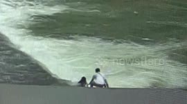 Passerby saves girl after she falls into fast-moving river in southwestern Chinese province