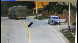 Tyre falls from lorry and lands on roof of parked car with driver inside