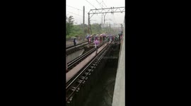 Mumbai commuters clamber out of train and over collapsed bridge