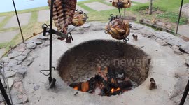Roasting meat in cages over open flame