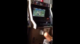 Kid with no arms playing arcade games with his feet