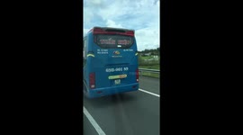 Bus driver seen steering packed coach with his FEET