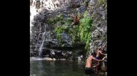 Crazy summer fun jumping into natural pool at waterfalls in langkawi- slo mo style.