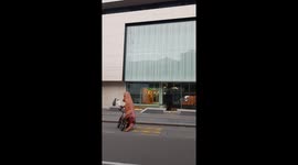biker with T-rex suite stunts and shows off