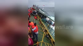 Newsflare Edit - Indonesia ferry tragedy footage shows passengers clinging to side of vessel