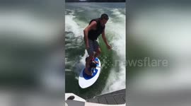 Surf’s up! Dog enjoys riding on surfboard with owner