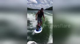 Surf’s up! Dog enjoys riding on surfboard with owner