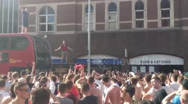 Raucous England crowd watches man fall through bus stop glass roof