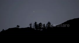 Bright Planet Venus setting behind Trees