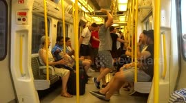 Boozy happy England football fans jump for joy on a tube train after England beat Sweden 2 - 0 in the World Cup quarter - finals