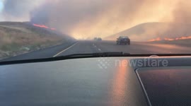 Fast-moving brush fire burns scarily close to California interstate