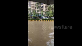 Monsoon rain floods streets in Mumbai causing travel disruption