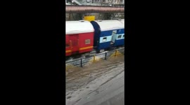 Trains slosh through floodwaters in Mumbai as city hit by heavy downpour
