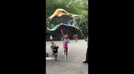 Slow-motion footage of New York man wowing children with giant bubble