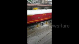 Trains slosh through floodwaters in Mumbai as city hit by heavy downpour