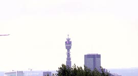 RAF Red Arrows centenary flypast over London's BT Tower streaming red, white and blue smoke