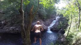 guy Jumps off rock into river in Australia
