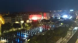 Flares light up night sky in Nice as fountains display Tricolour