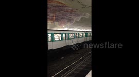 French fans jump and cheer in excitement inside departing Metro train