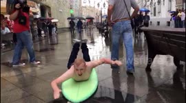 England fan surfs through the torrential rain in Moscow