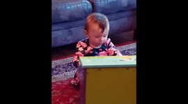 13 month old baby girl plays a mini piano for first time.